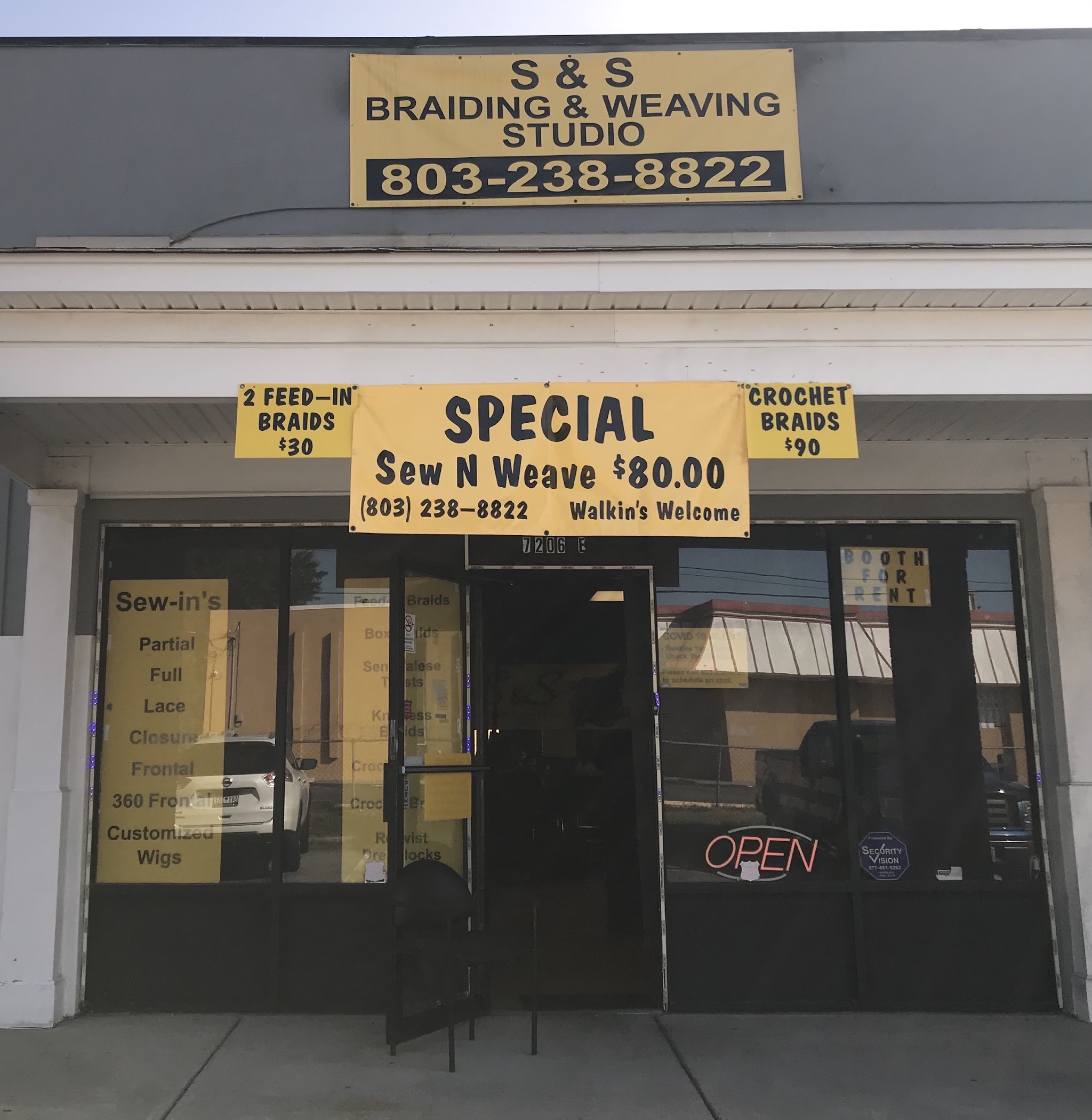 The studio storefront with our sign and walk-in specials