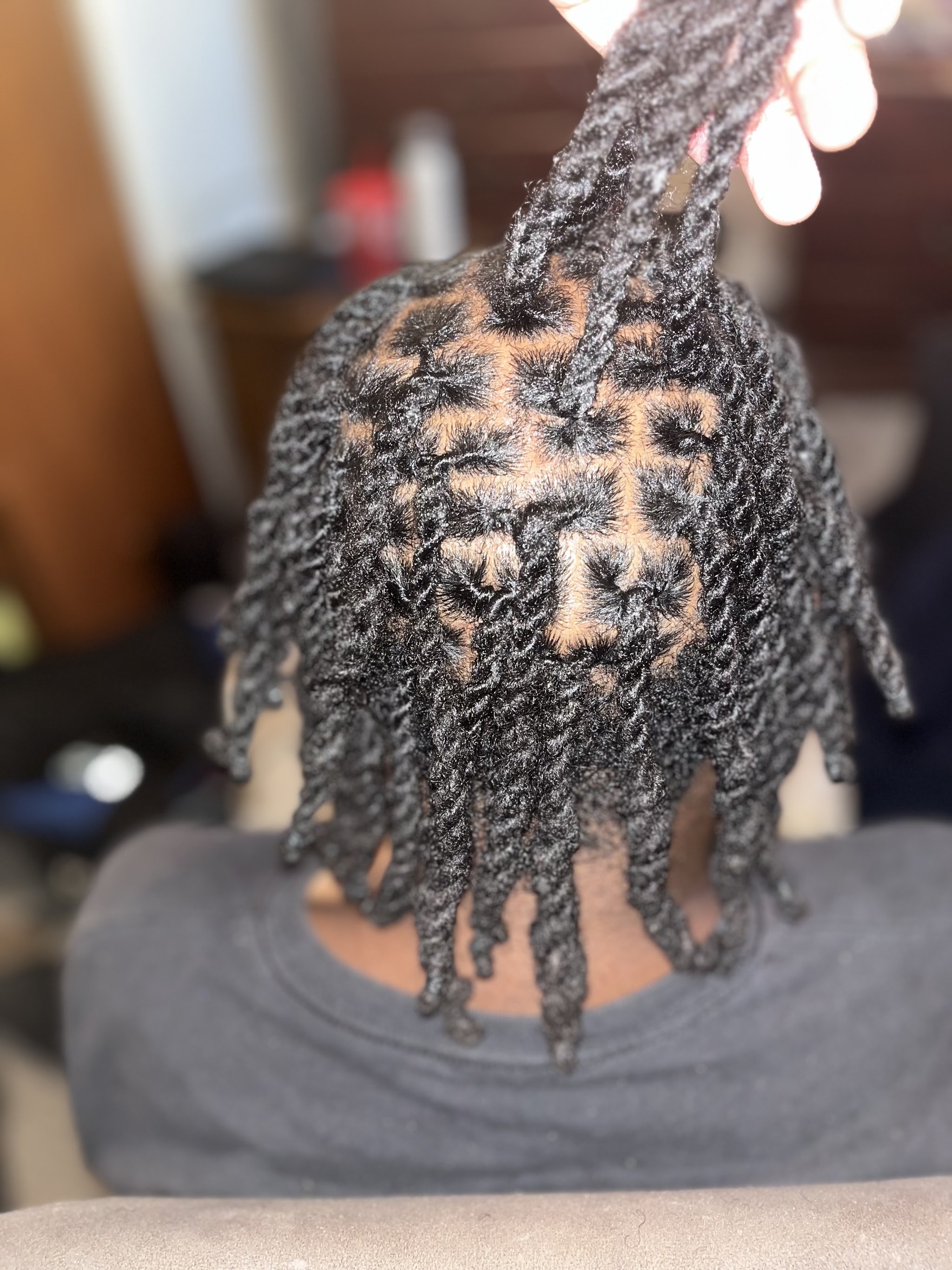 Starter locs with a neat diamond parting