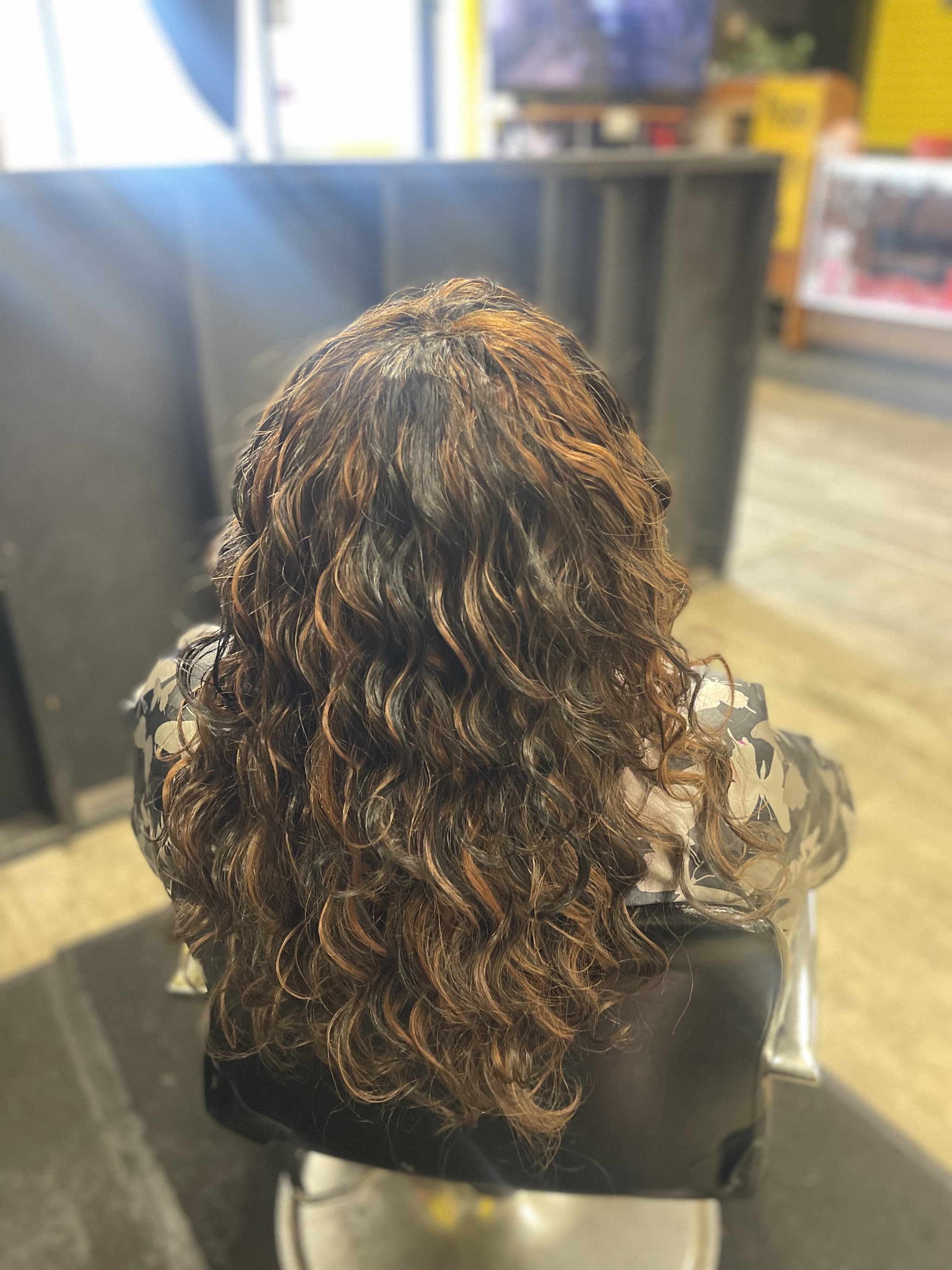 Auburn curls finished in the salon chair